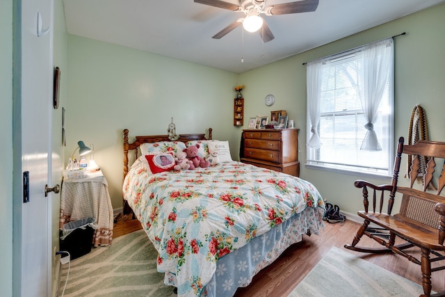 bedroom with hardwood / wood-style flooring and ceiling fan