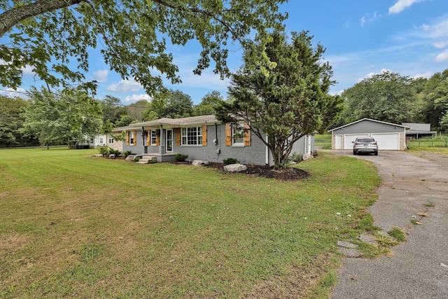 single story home featuring an outdoor structure, a garage, and a front yard