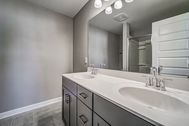 bathroom with vanity, tile patterned floors, and a shower with shower door