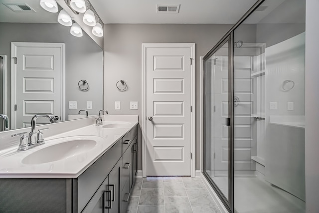 bathroom with walk in shower, tile patterned flooring, and vanity