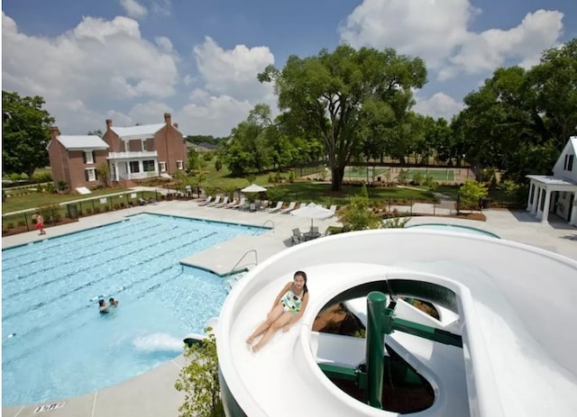 view of swimming pool featuring a patio area and a jacuzzi