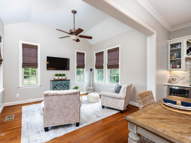 living room with plenty of natural light, hardwood / wood-style floors, and lofted ceiling