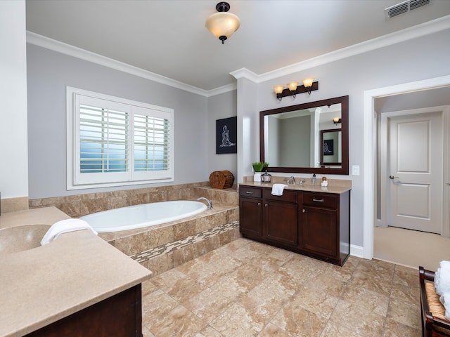 bathroom with tiled bath, crown molding, and vanity