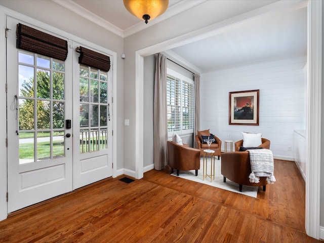 doorway to outside with crown molding, hardwood / wood-style floors, and plenty of natural light