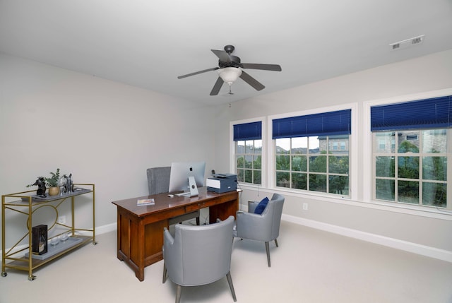 carpeted home office with ceiling fan