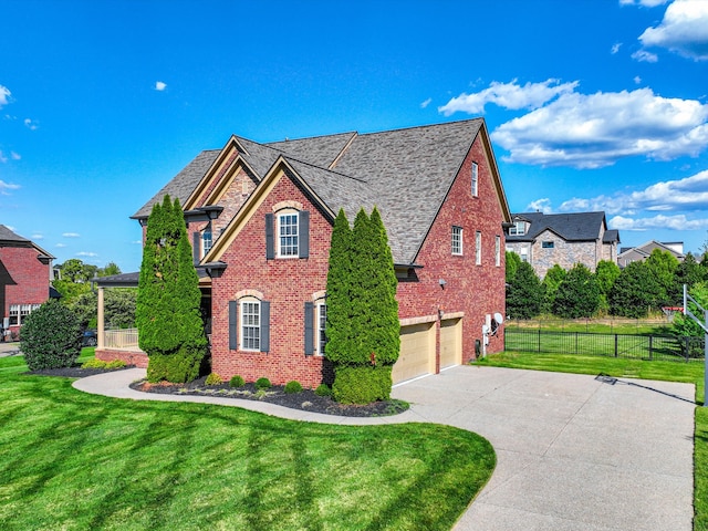 view of side of property with a lawn and a garage