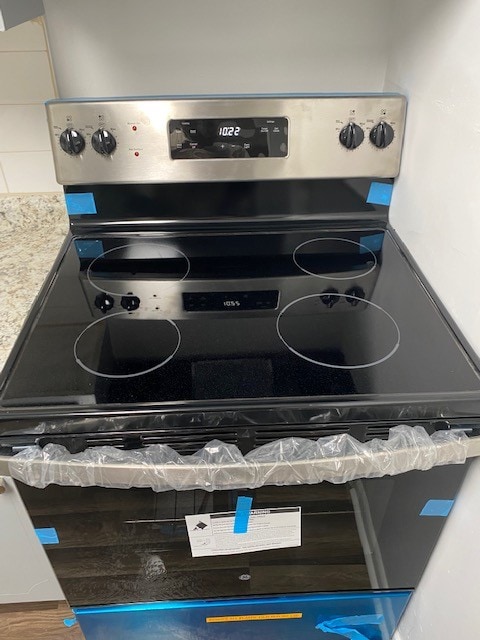 interior details with stainless steel range with electric cooktop