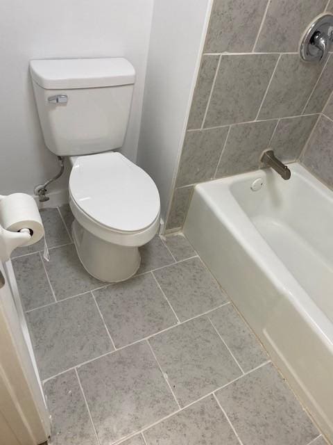 bathroom featuring toilet, baseboards, and tile patterned floors