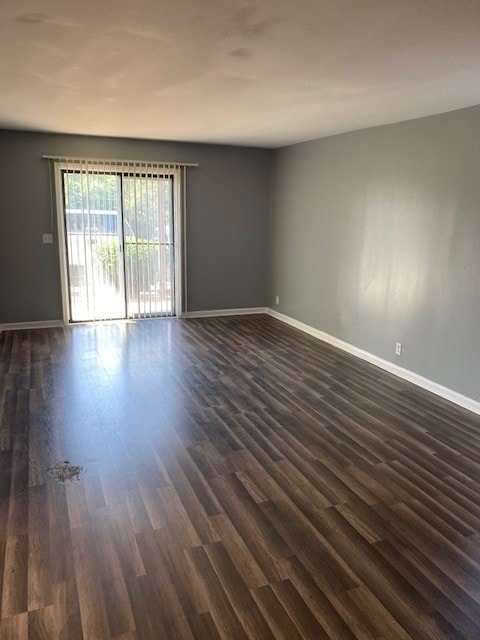 unfurnished room featuring dark wood-type flooring