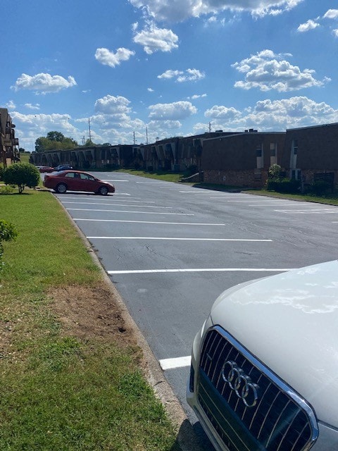 view of car parking featuring a yard