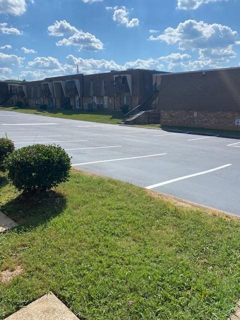 uncovered parking lot with community basketball court