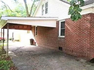 view of side of home with a carport