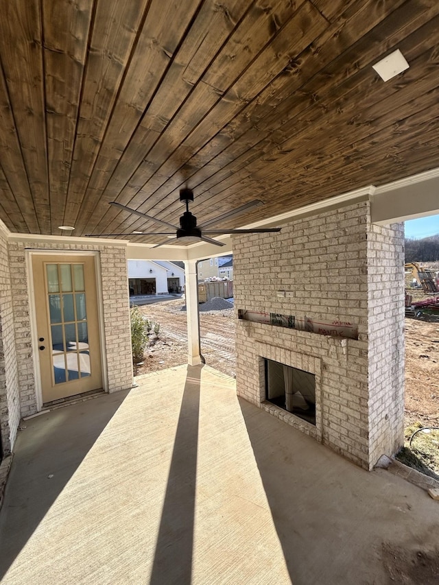 view of patio / terrace with ceiling fan and an outdoor brick fireplace