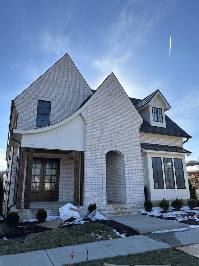 view of front of property with french doors and brick siding