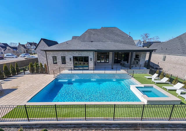 view of swimming pool featuring a patio area and an in ground hot tub