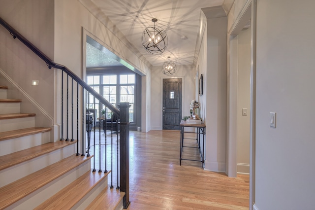 entrance foyer with a notable chandelier and light wood-type flooring