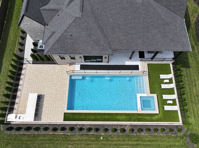 view of pool with a lawn