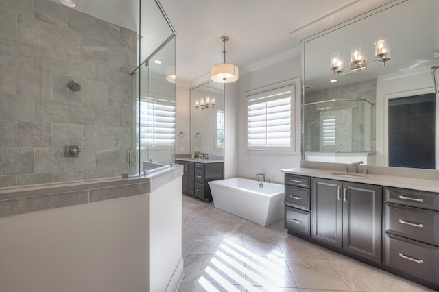 bathroom featuring vanity, a notable chandelier, tile patterned flooring, ornamental molding, and independent shower and bath