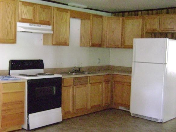 kitchen featuring white appliances and sink