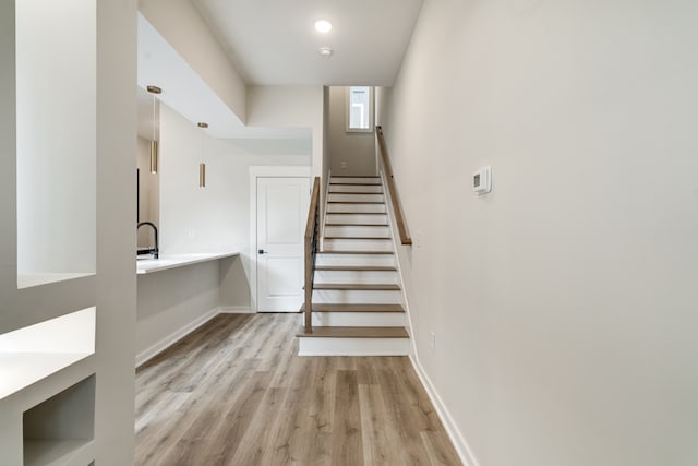 stairway with hardwood / wood-style flooring