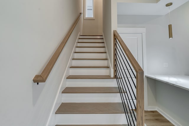 stairs featuring hardwood / wood-style flooring