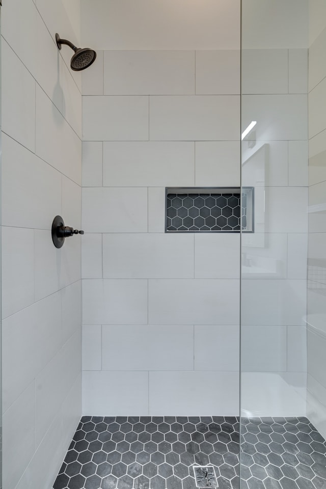 bathroom with a tile shower