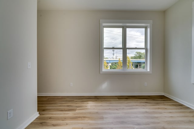 empty room with light hardwood / wood-style flooring