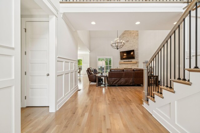 foyer entrance featuring light wood-type flooring and a fireplace