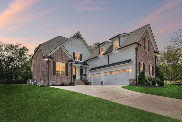 view of front facade featuring a garage, a yard, and central air condition unit