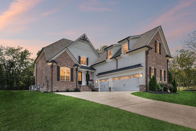 view of front of house featuring a standing seam roof, driveway, a front lawn, and board and batten siding