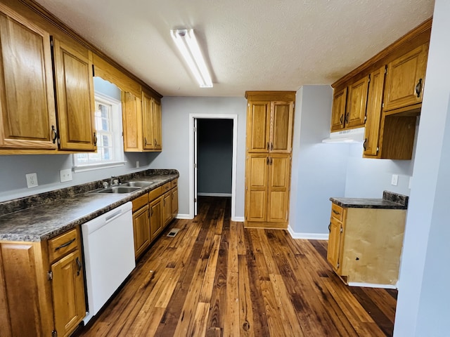 kitchen featuring sink, dark wood-type flooring, a textured ceiling, and white dishwasher