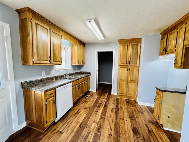 kitchen featuring dark wood-type flooring, white dishwasher, sink, and a textured ceiling