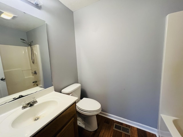 full bathroom with shower / tub combination, wood-type flooring, vanity, and toilet