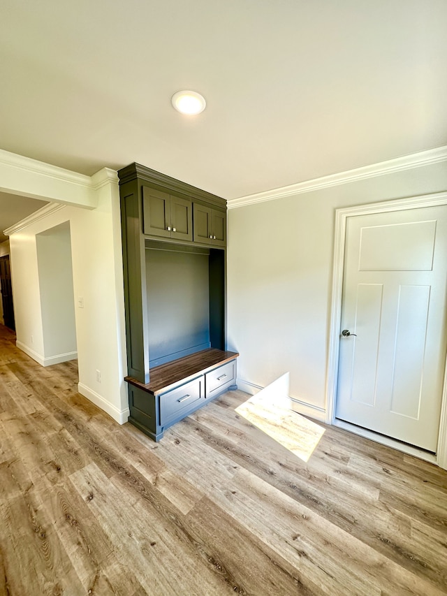 mudroom with light wood-type flooring and ornamental molding