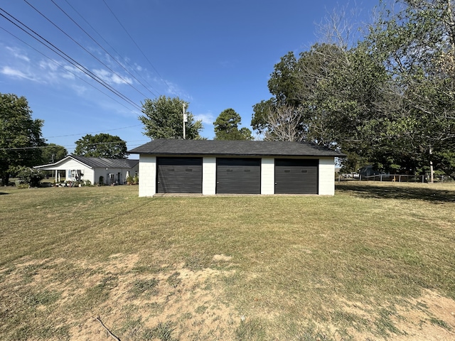 garage featuring a lawn