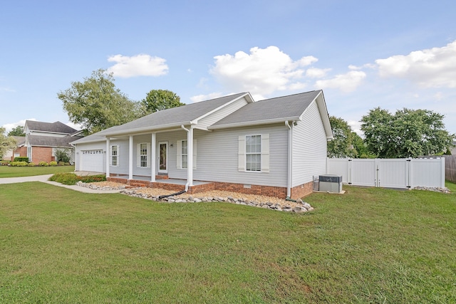 view of front of house featuring a garage, covered porch, central AC, and a front yard