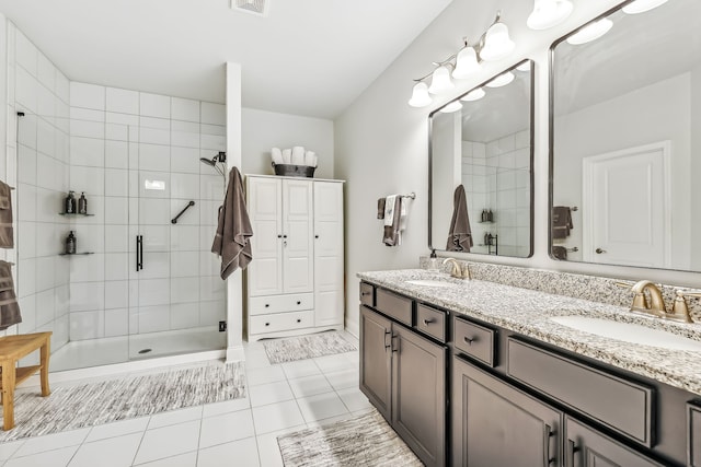 bathroom featuring walk in shower, tile patterned flooring, and vanity