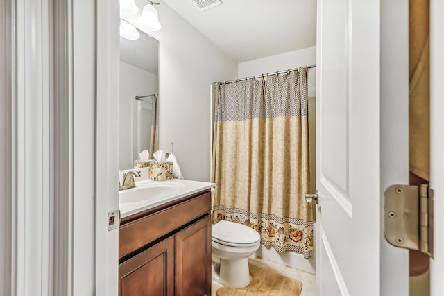 full bathroom featuring vanity, tile patterned flooring, toilet, and shower / tub combo