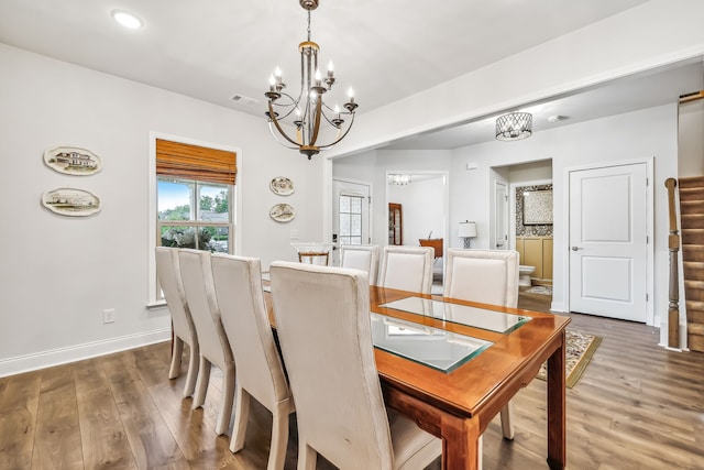 dining room with an inviting chandelier and dark hardwood / wood-style floors