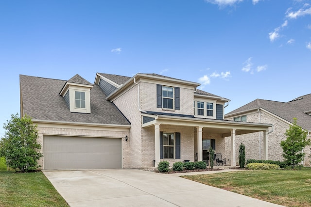 view of front facade with a garage and a front lawn