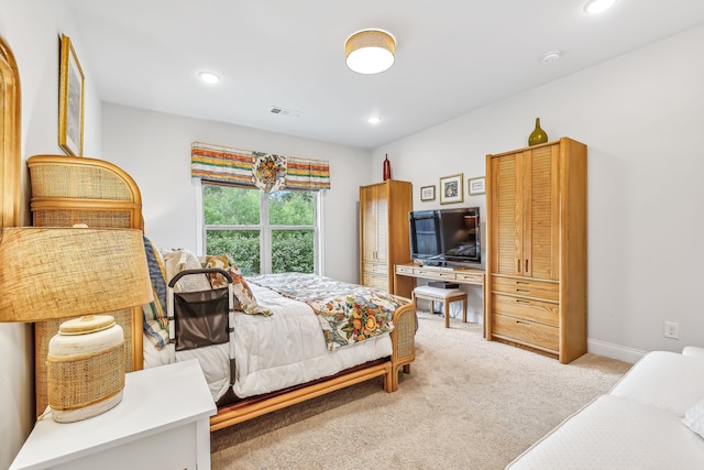 bedroom featuring light colored carpet