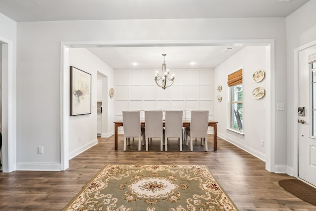 dining space featuring a chandelier and dark wood-type flooring