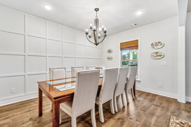 dining space featuring a notable chandelier and light hardwood / wood-style flooring