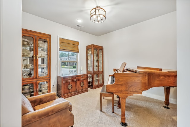 sitting room featuring light carpet and a chandelier