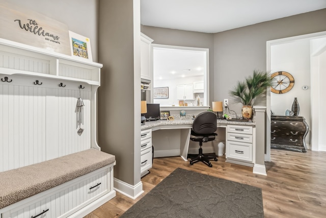 office featuring built in desk and dark wood-type flooring