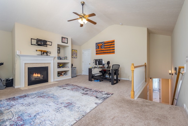 living room featuring built in shelves, ceiling fan, light carpet, and vaulted ceiling