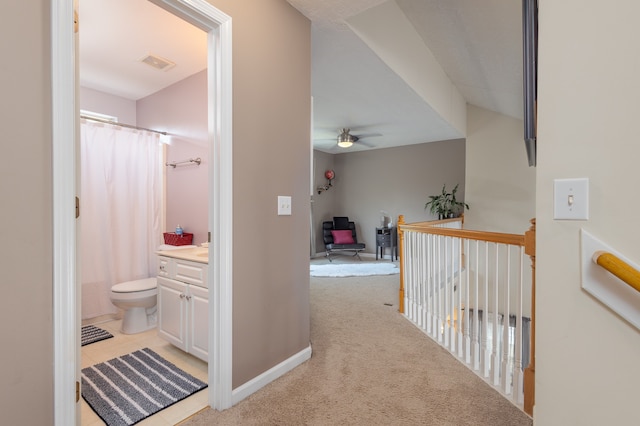 hallway with light colored carpet