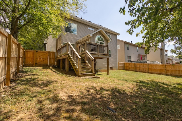 rear view of property featuring a lawn and a deck