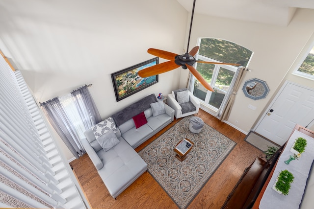 living room with high vaulted ceiling, wood-type flooring, and ceiling fan