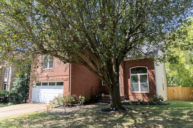 view of front of house with a garage and a front lawn